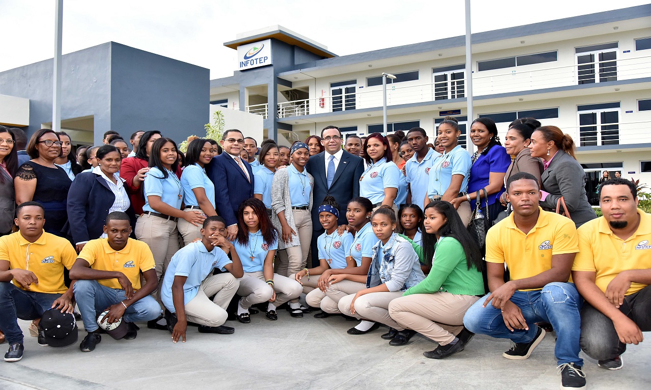  imagen Ministro de educaci&oacute;n Andres Navarro junto a director Rafael Ovalles y&nbsp; grupo de estudiantes de Infotep. Uno de los estudiantes realiza una demostraci&oacute;n flojando tuerca de un motor. 