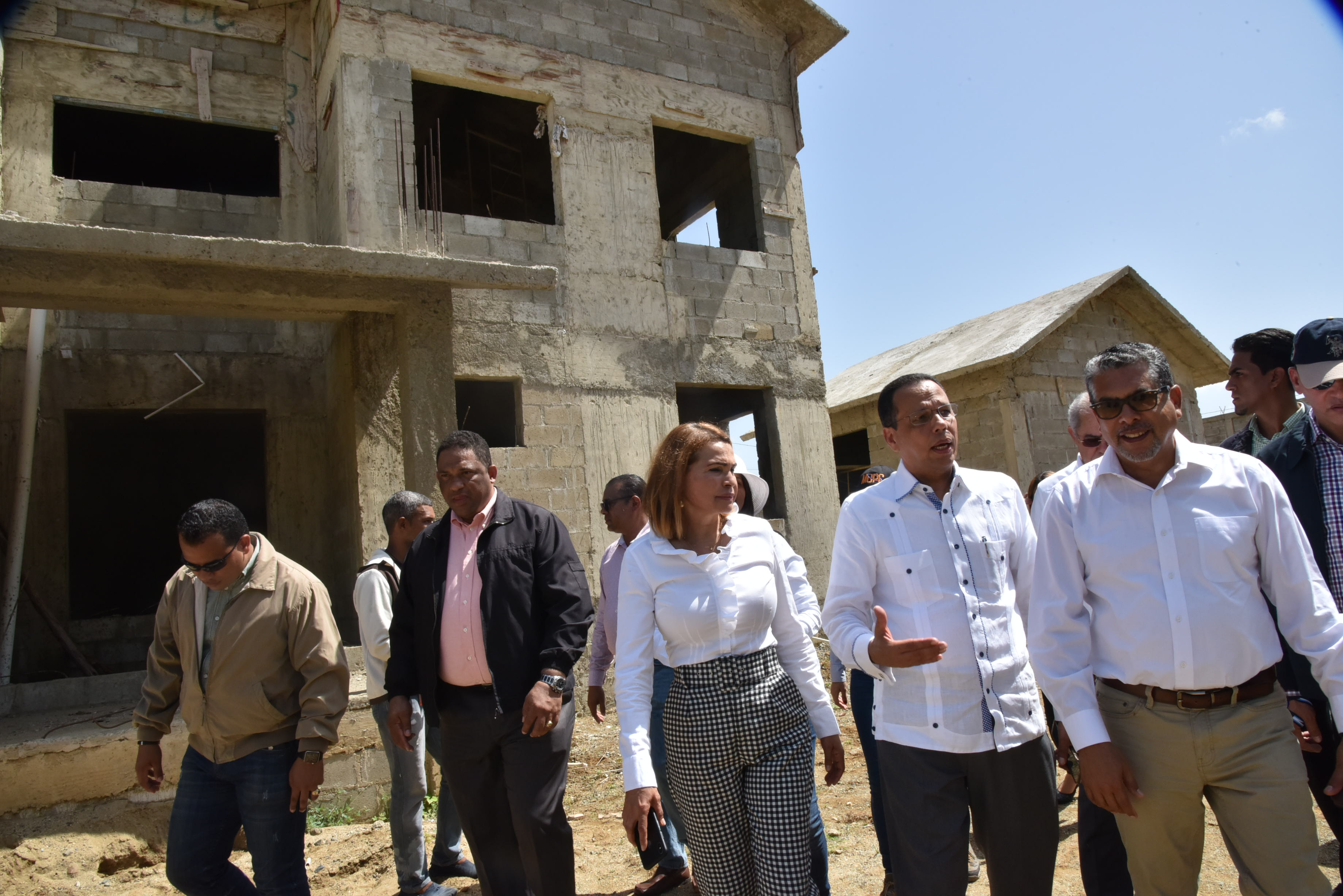  imagen Ministro de educaci&oacute;n conversa con sus acompa&ntilde;antes mientras recorre una de las contrucciones. 