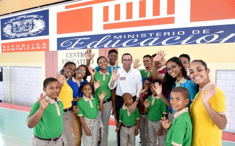  imagen Ministro Andres Navarro junto a estudiantes saludando de pie.&nbsp; 